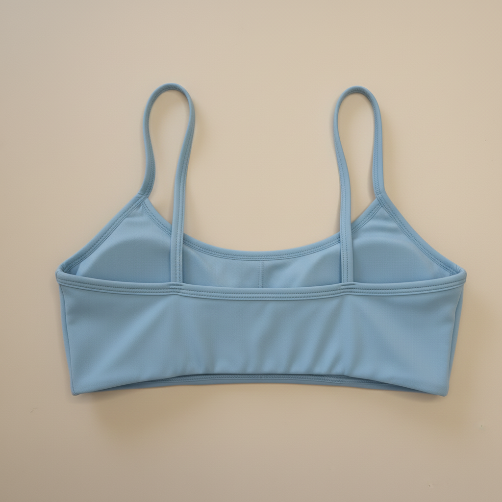 Blue sports bra back view on cream background - no logo